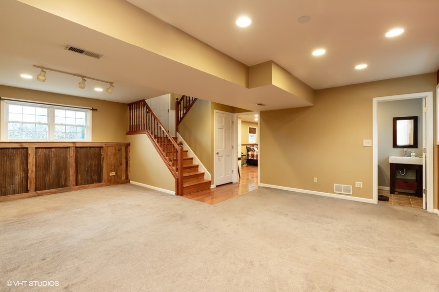 136 Tree Line Antioch, IL 60002 - Photo 13 of 17 an empty room with wooden floor and windows
