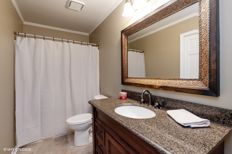 136 Tree Line Antioch, IL 60002 - Photo 9 of 17 a bathroom with a granite countertop sink and a mirror with toilet