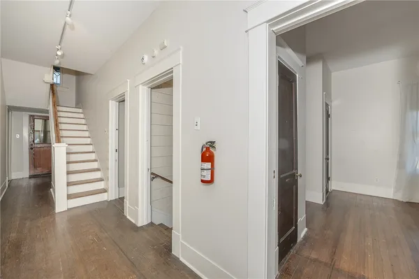 a view of a room with wooden floor and white walls