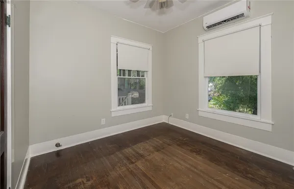 a bedroom with a bed and large windows