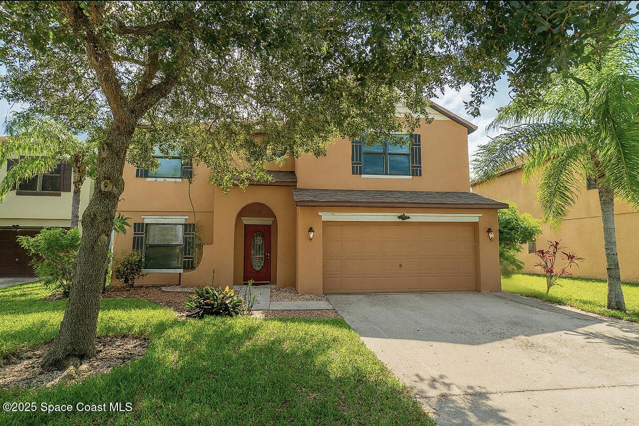 285 Dryden Circle Cocoa, FL 32926 - Photo 1 of 61 a front view of a house with a garden and trees