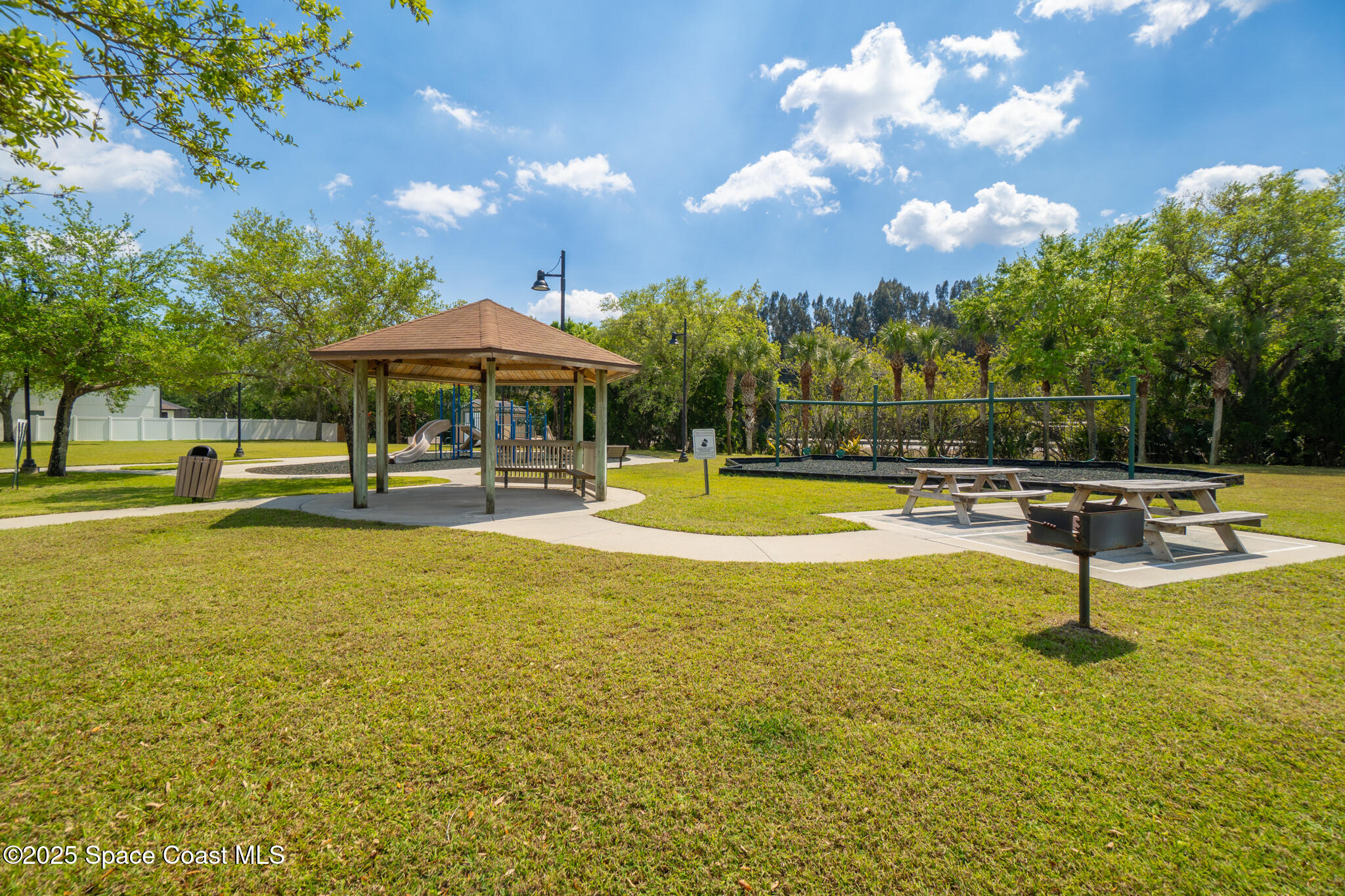 285 Dryden Circle Cocoa, FL 32926 - Photo 43 of 61 a view of a swimming pool with an outdoor seating and a yard
