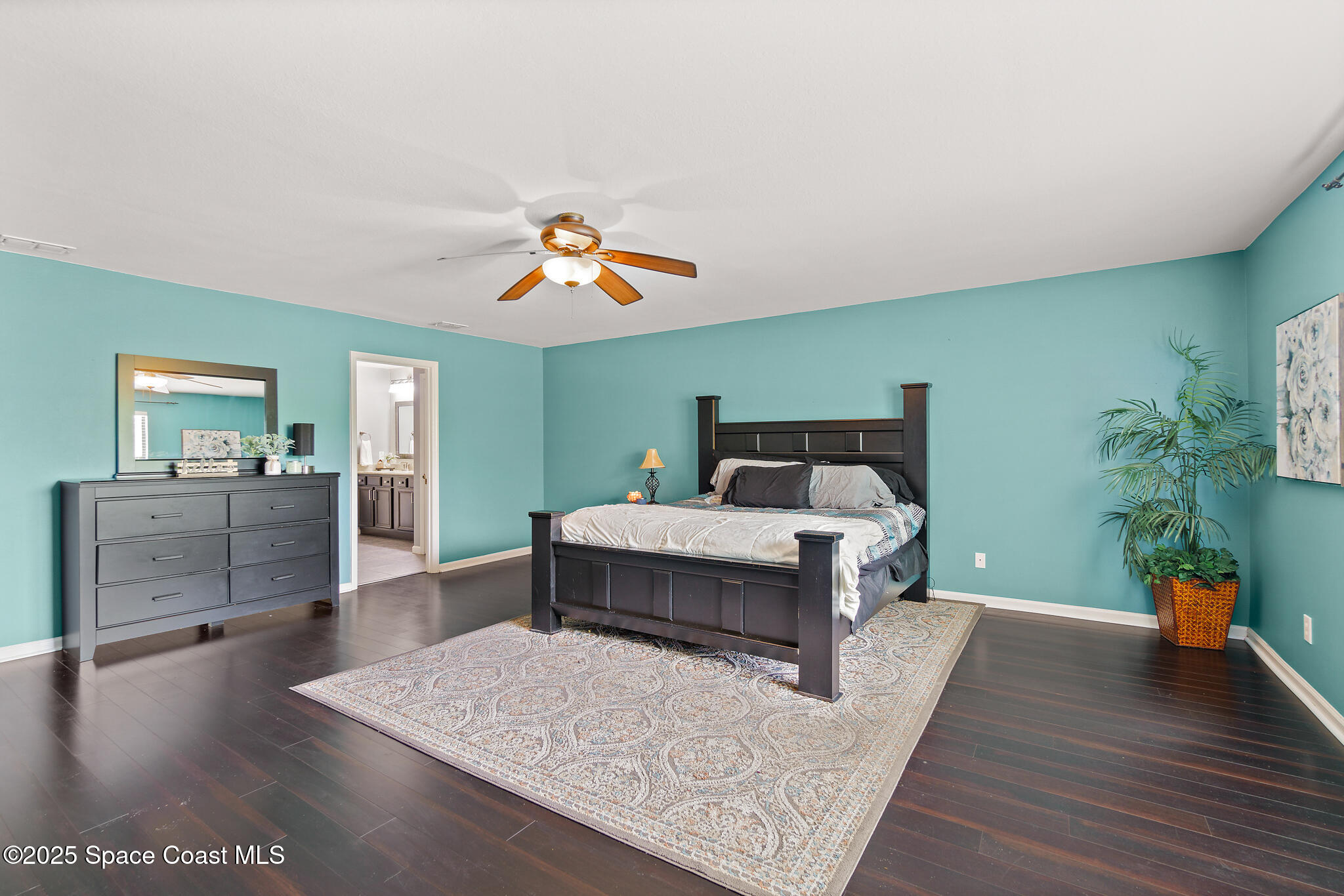 285 Dryden Circle Cocoa, FL 32926 - Photo 7 of 61 a bedroom with a bed and a chandelier