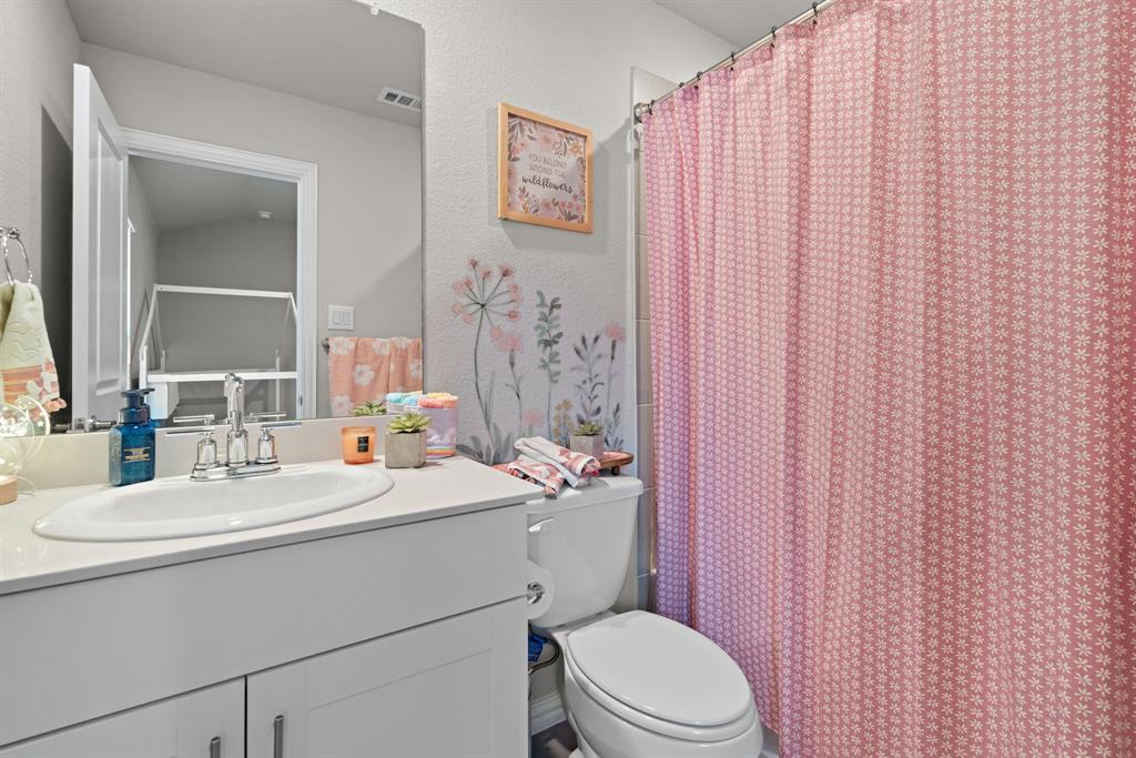 3112 Kingsgarden Road Denton, TX 76207 - Photo 23 of 38 Bathroom featuring a single vanity with a white countertop and undermount sink, chrome faucet, and a toilet