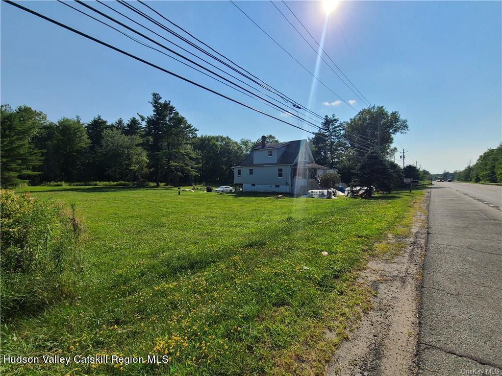275-277 State Rt 17B Monticello, NY 12701 - Photo 17 of 32 a view of a big yard with a house in the background