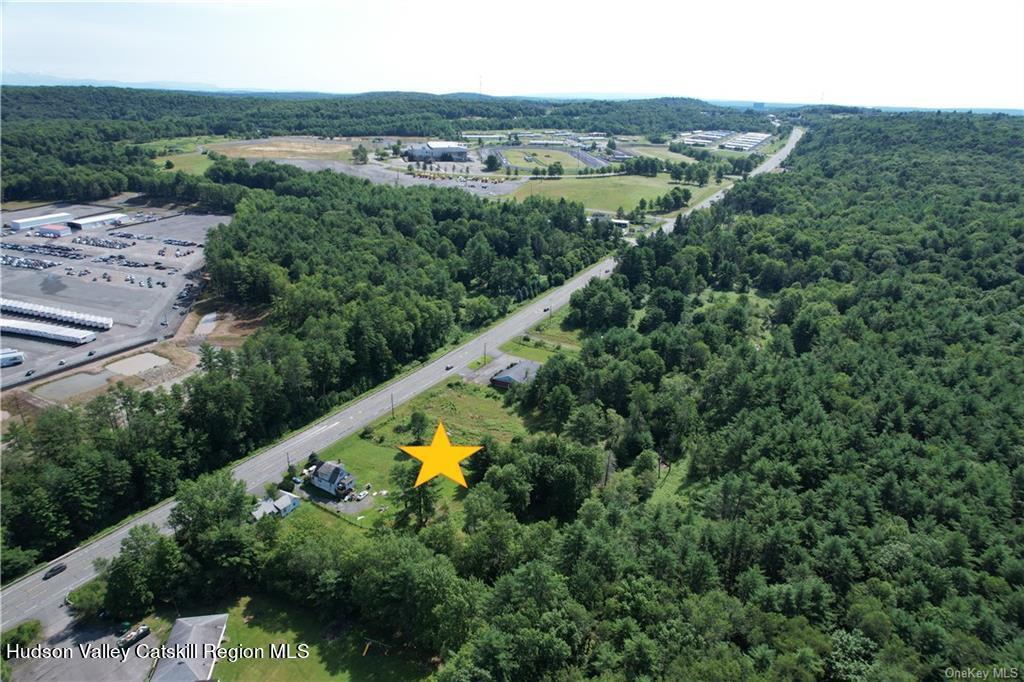 275-277 State Rt 17B Monticello, NY 12701 - Photo 23 of 32 an aerial view of residential houses with outdoor space and swimming pool