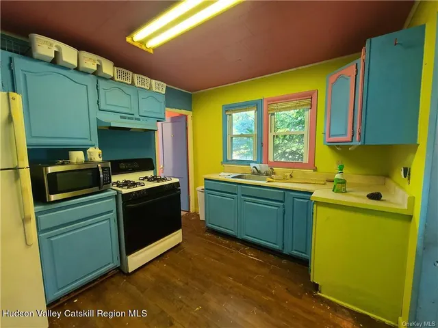 a kitchen with sink and wooden cabinets