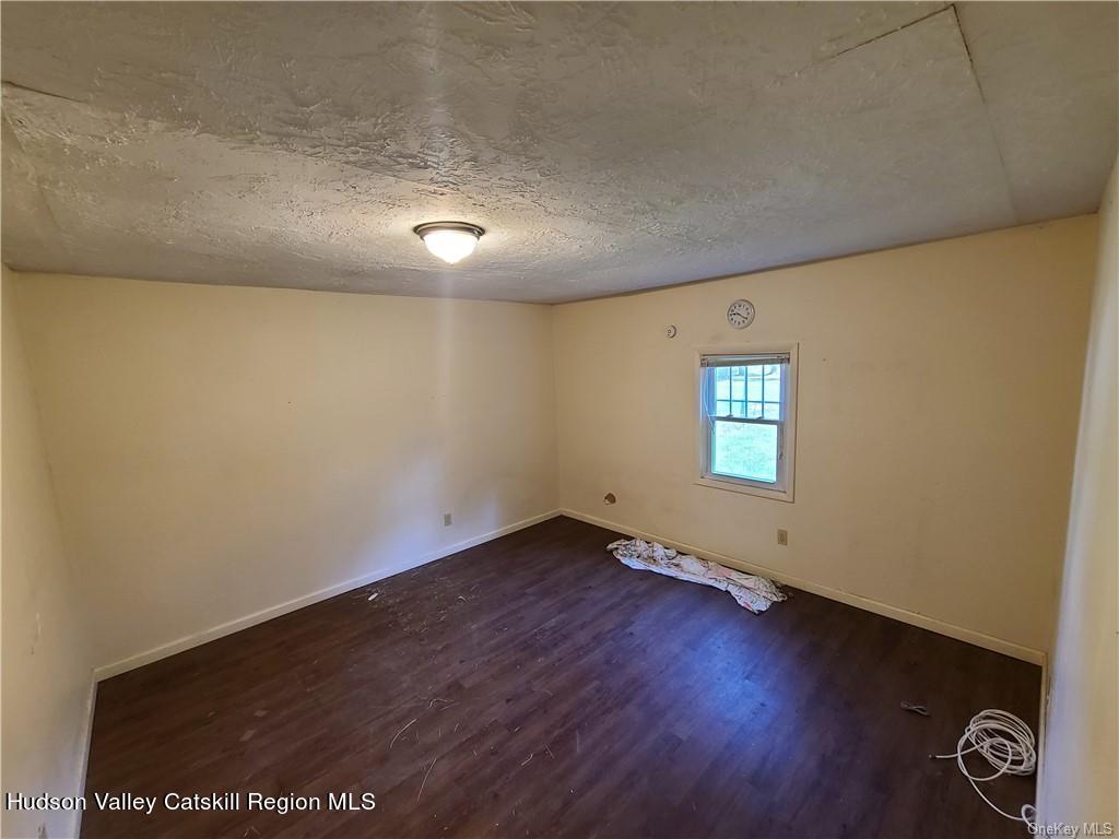 275-277 State Rt 17B Monticello, NY 12701 - Photo 7 of 32 an empty room with a empty space and windows