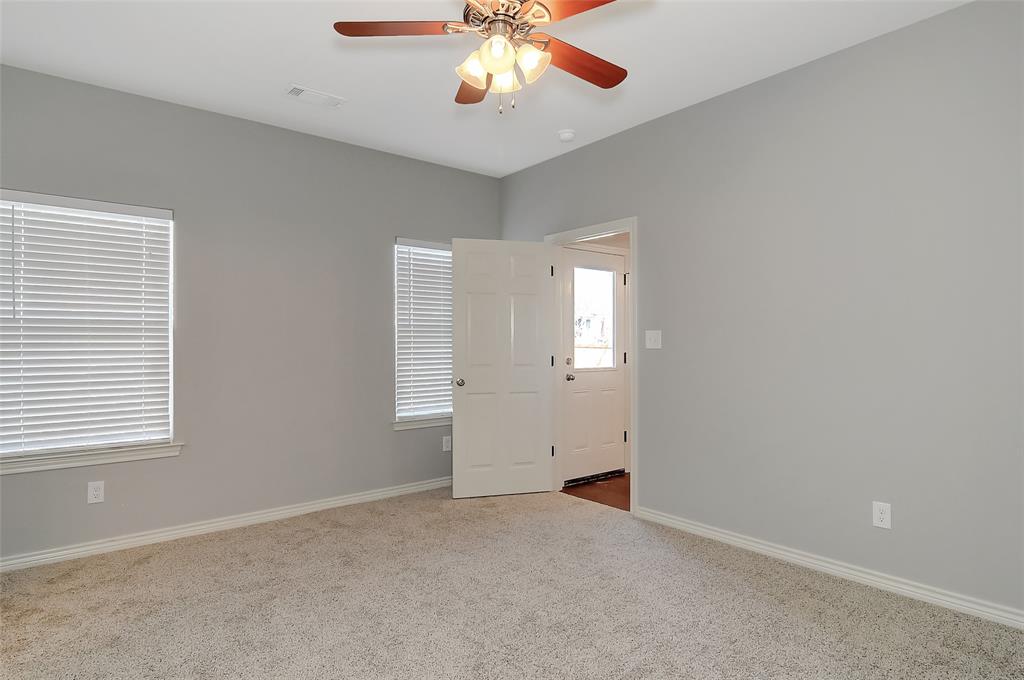 613 East Rosedale Street Sherman, TX 75090 - Photo 12 of 21 an empty room with windows and chandelier fan