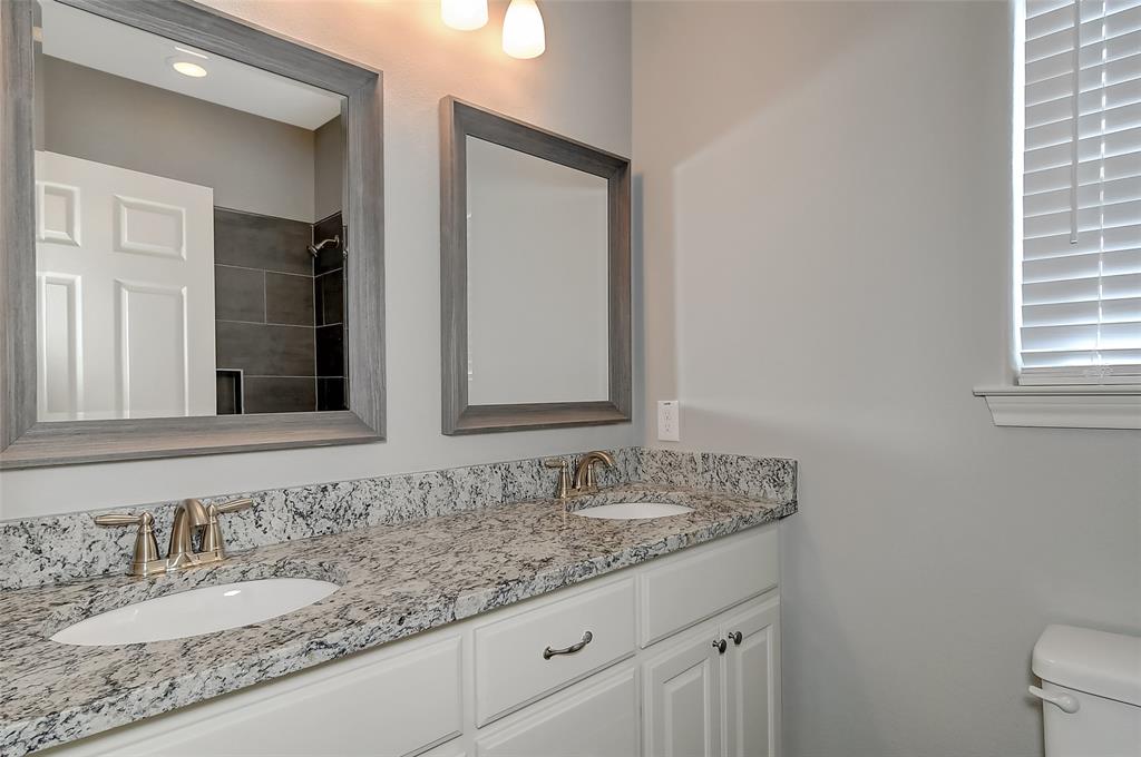 613 East Rosedale Street Sherman, TX 75090 - Photo 13 of 21 a bathroom with a granite countertop sink and a mirror