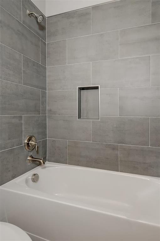 613 East Rosedale Street Sherman, TX 75090 - Photo 14 of 21 a bathroom with a shower and a bathtub