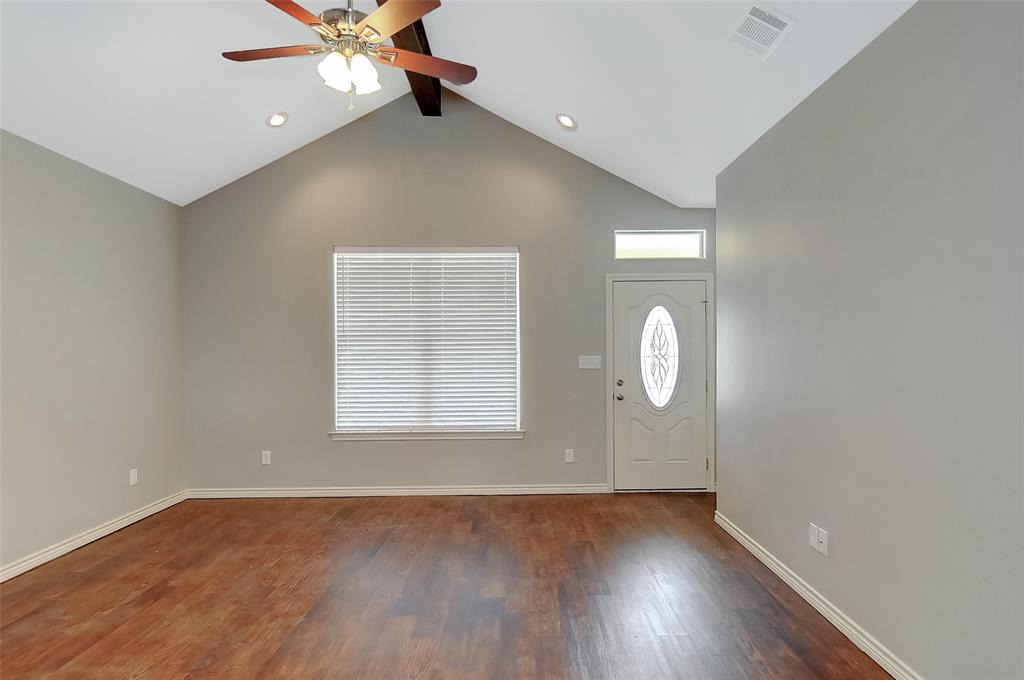 613 East Rosedale Street Sherman, TX 75090 - Photo 4 of 21 an empty room with wooden floor and windows