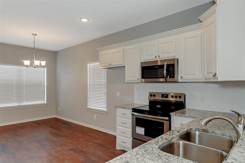 613 East Rosedale Street Sherman, TX 75090 - Photo 6 of 21 a kitchen with a sink and a microwave