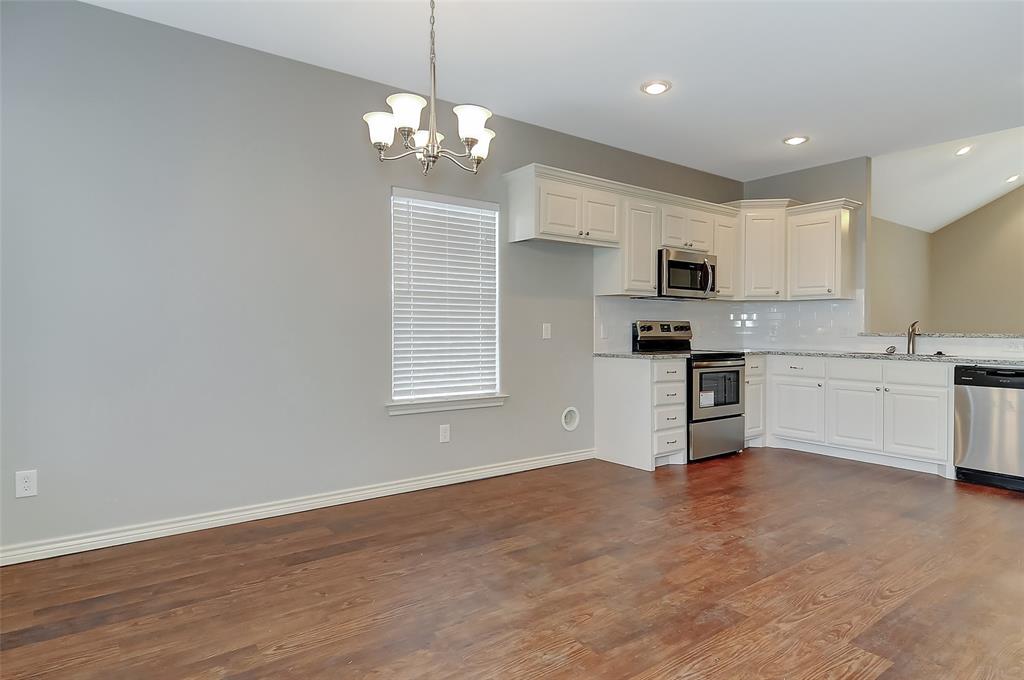 613 East Rosedale Street Sherman, TX 75090 - Photo 10 of 21 a view of kitchen with granite countertop stainless steel appliances cabinets a sink and a window