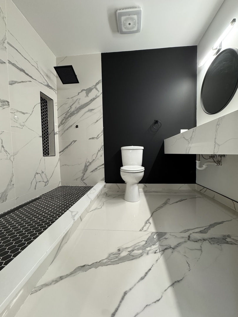 395 Surrey Lane Crete, IL 60417 - Photo 13 of 26 a bathroom with a sink a toilet and shower