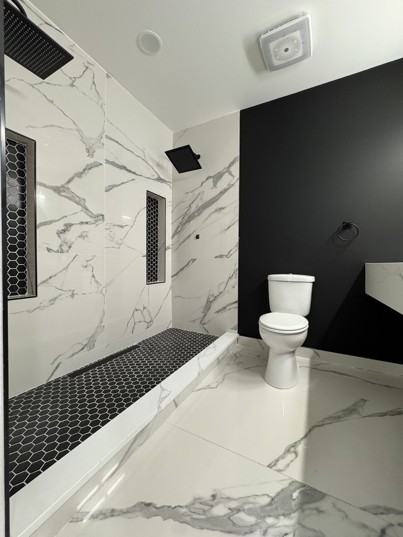 395 Surrey Lane Crete, IL 60417 - Photo 14 of 26 a bathroom with a toilet and a shower