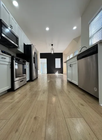 a view of a kitchen with a sink and an oven