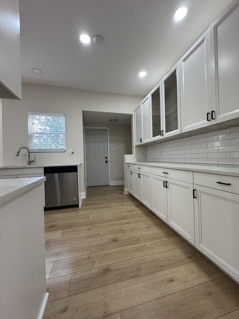 395 Surrey Lane Crete, IL 60417 - Photo 22 of 26 a kitchen with stainless steel appliances granite countertop a sink and a stove top oven