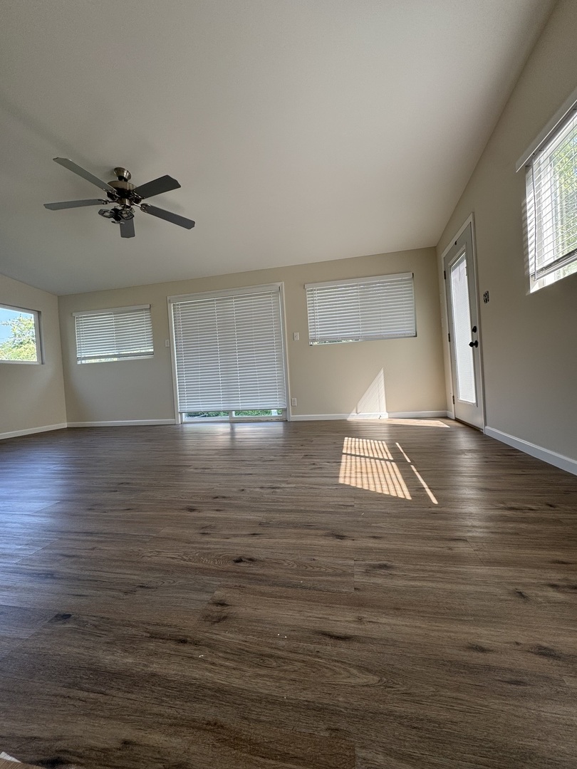 395 Surrey Lane Crete, IL 60417 - Photo 24 of 26 a view of empty room with wooden floor and fan