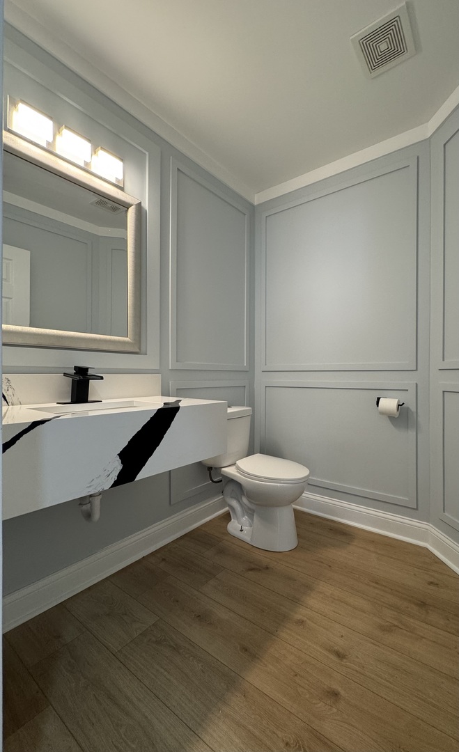 395 Surrey Lane Crete, IL 60417 - Photo 8 of 26 a bathroom with a toilet a sink and mirror