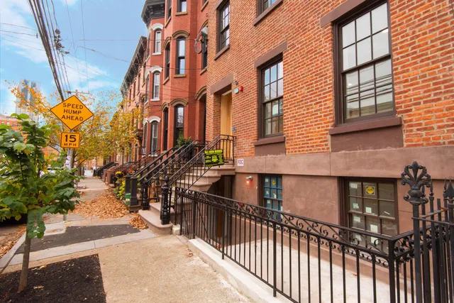 a view of a brick house with many windows