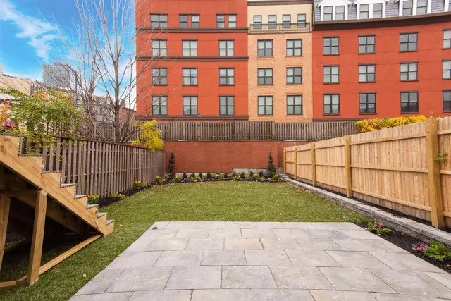 a view of a brick building next to a yard