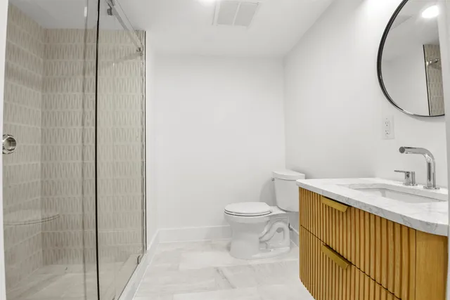 a bathroom with a sink a toilet and a mirror