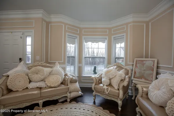 a kitchen with granite countertop a white cabinets and a chandelier