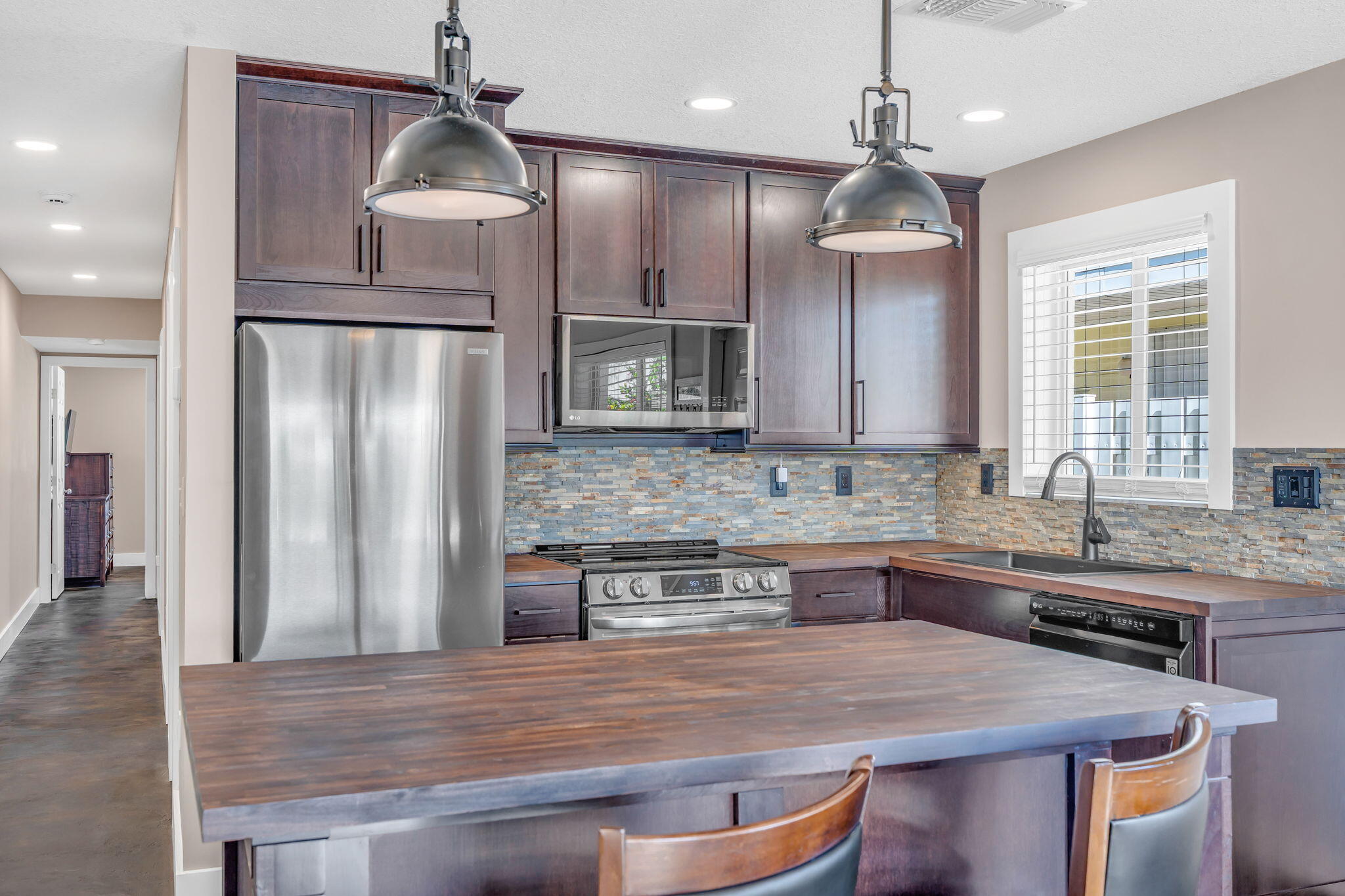 4 7th Street Key Colony Beach, FL 33051 - Photo 4 of 44 a kitchen with kitchen island granite countertop a sink stove and refrigerator