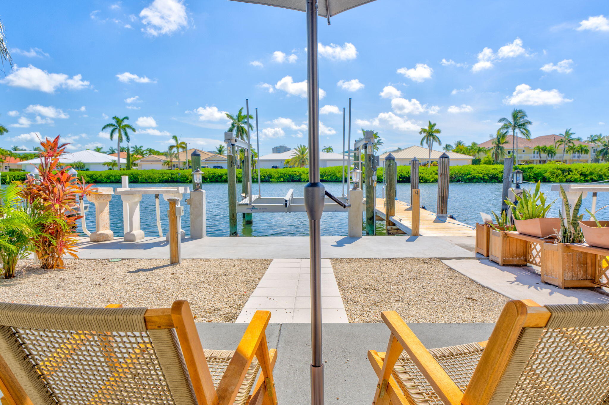 4 7th Street Key Colony Beach, FL 33051 - Photo 8 of 44 a view of a patio with a table and chairs and potted plants