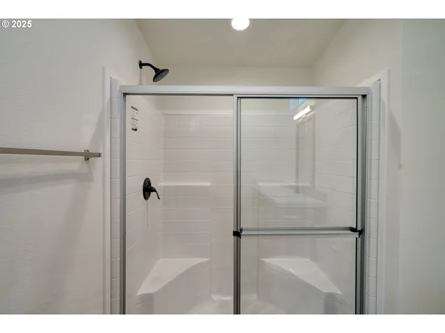 a bathroom with a glass shower door