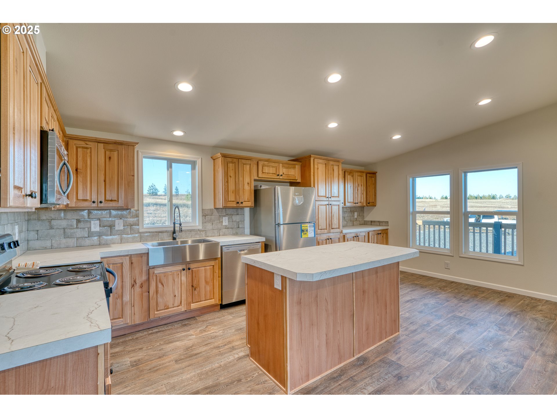 955 High Prairie Road Lyle, WA 98635 - Photo 3 of 35 a kitchen with a sink and wooden cabinets