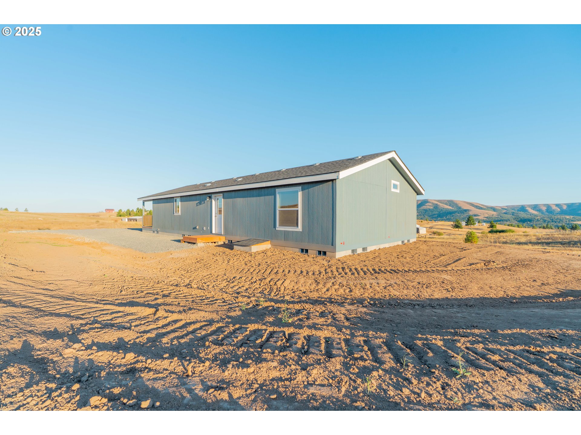 955 High Prairie Road Lyle, WA 98635 - Photo 34 of 35 a bedroom with a bed and a flat screen tv