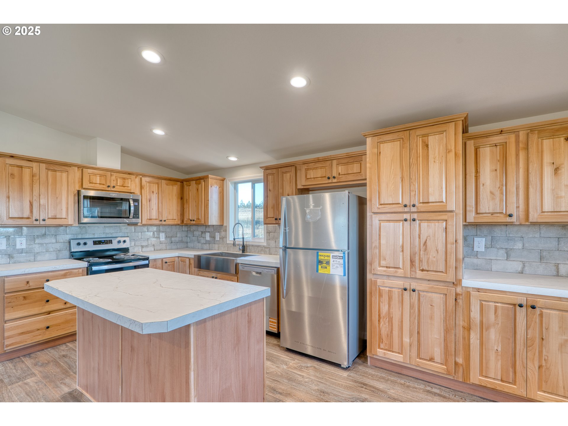 955 High Prairie Road Lyle, WA 98635 - Photo 8 of 35 a kitchen with stainless steel appliances granite countertop a refrigerator a stove a sink a microwave and with wooden cabinets