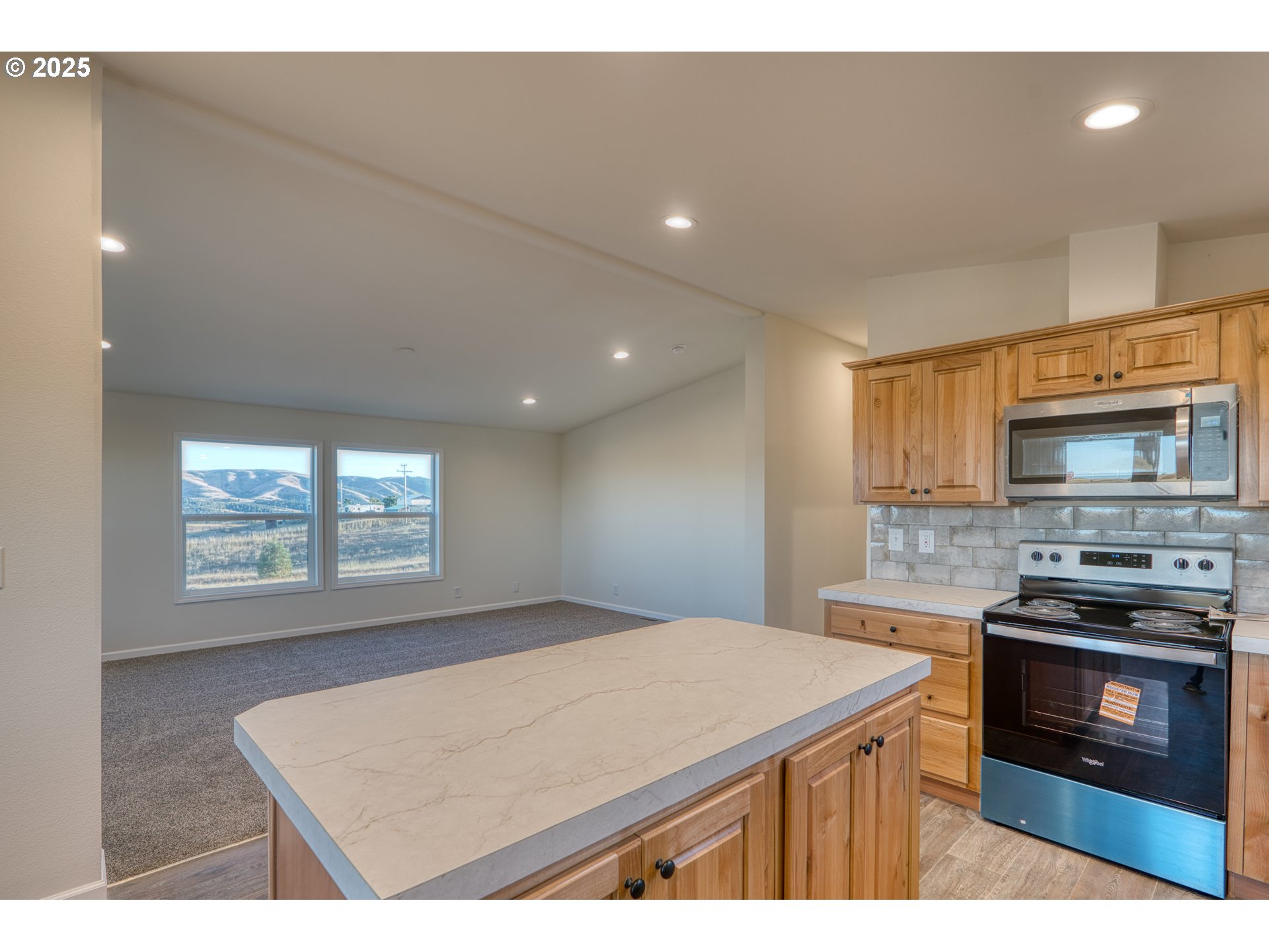 955 High Prairie Road Lyle, WA 98635 - Photo 9 of 35 a kitchen with a stove a sink and a microwave
