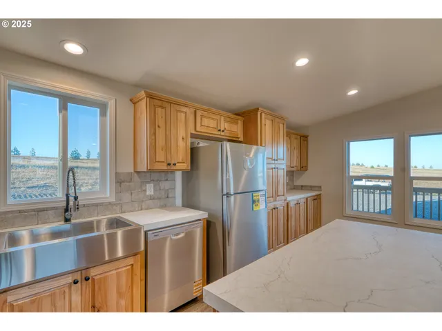 a kitchen with a refrigerator a sink and a cabinets