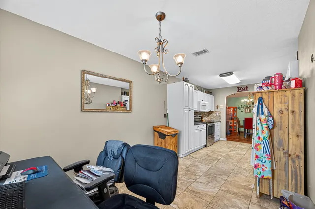 a bedroom with a bed a window and dresser