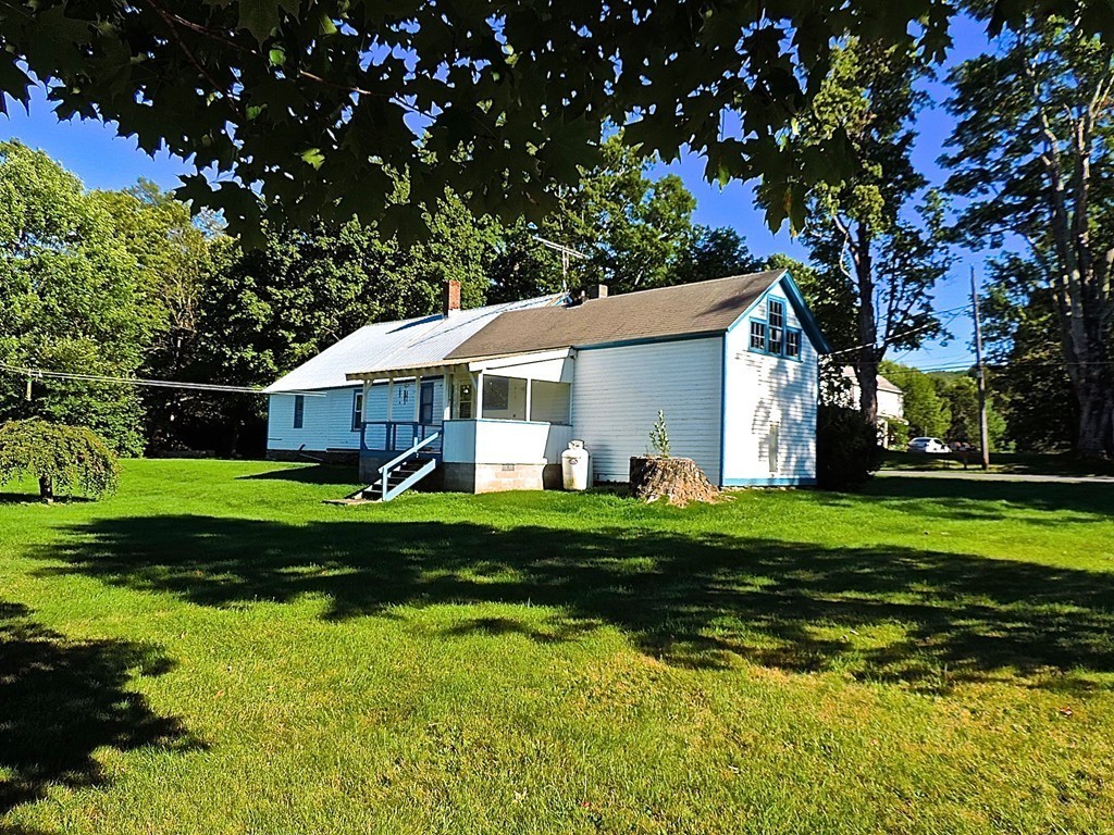 50 Creamery Road Ashfield, MA 01330 - Photo 2 of 24 a front view of a house with a yard table and chairs