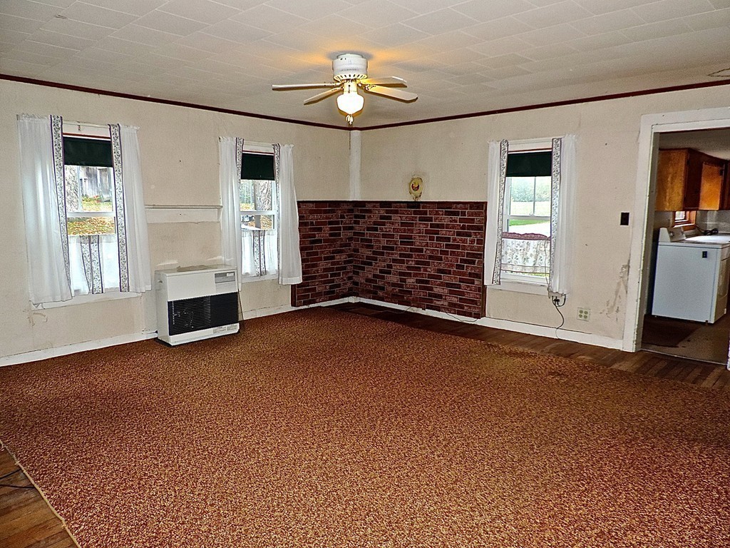50 Creamery Road Ashfield, MA 01330 - Photo 8 of 24 a view of an empty room with a fireplace and a window
