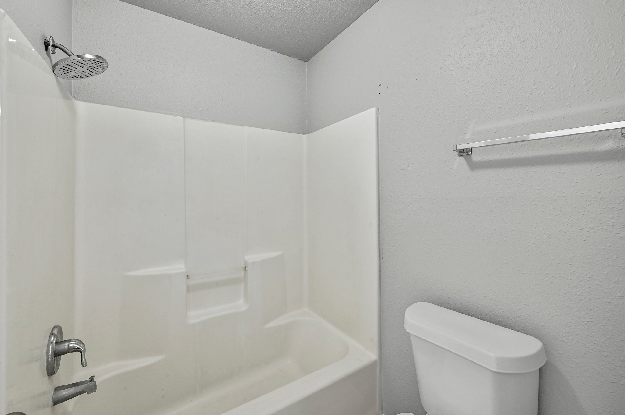 2212 Katy Lane Georgetown, TX 78626 - Photo 21 of 27 Bathroom featuring a white bathtub and shower combination with a chrome showerhead and faucet
