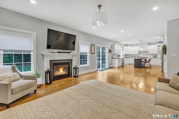 a living room with furniture fireplace and flat screen tv