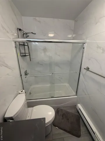 a bathroom with a shower and toilet