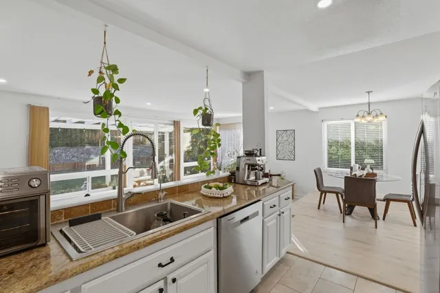 a very nice looking living room with a potted plant