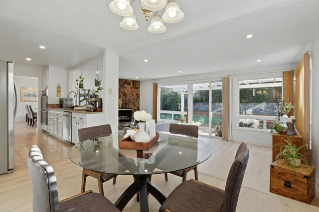 a view of a dining room with furniture large windows and wooden floor