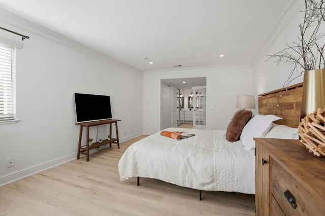 a bedroom with a bed and a flat screen tv