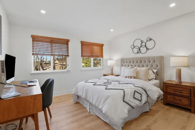 a bedroom with a bed and a desk