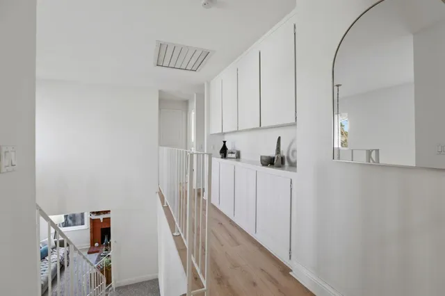 a view of hallway with wooden floor