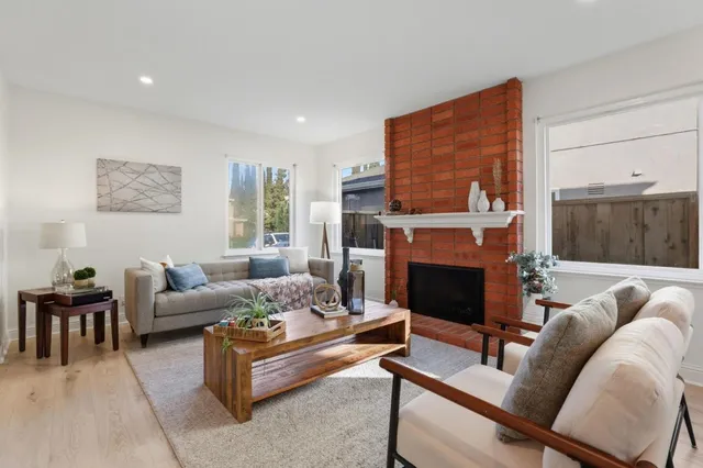 a living room with furniture and a fireplace