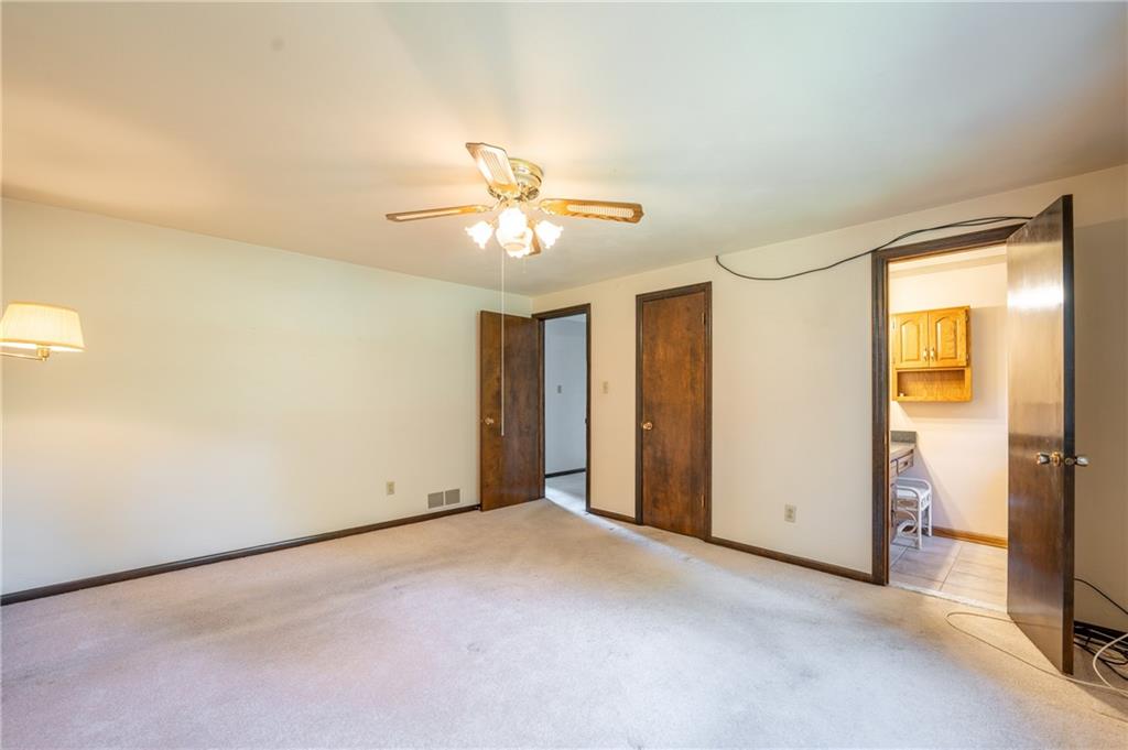 756 Arona Road New Stanton, PA 15672 - Photo 17 of 35 an empty room with a ceiling fan and a window