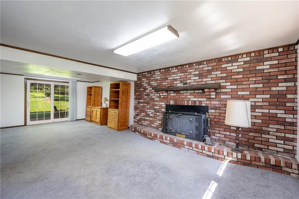 756 Arona Road New Stanton, PA 15672 - Photo 19 of 35 a view of an empty room with a fireplace and a window